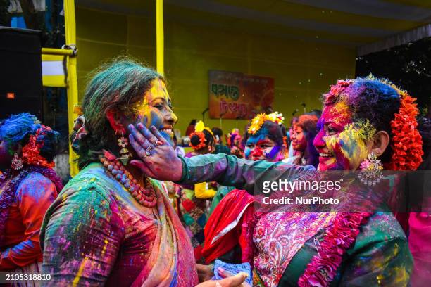 Women are playing with colored powder during the Holi festival in Kolkata, India, on March 25, 2024.