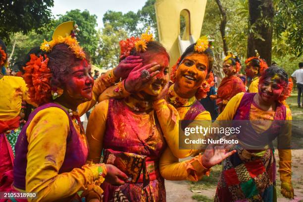 Girls are playing with colored powder during the Holi festival in Kolkata, India, on March 25, 2024.