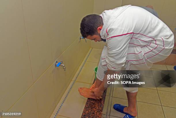 The Imam's assistant of the Islamic mosque of Vendrell Abdul Rezak performs the ablution process by washing his feet three times before Ramadan...