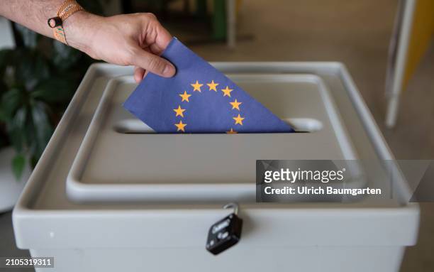 This photo illustration shows a hand placing a card with the EU symbol into a ballot box on March 25, 2024 in Bonn, Germany. The European elections...