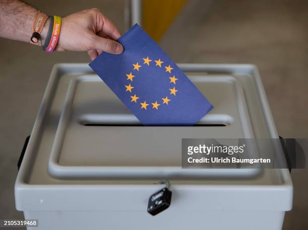 This photo illustration shows a hand placing a card with the EU symbol into a ballot box on March 25, 2024 in Bonn, Germany. The European elections...
