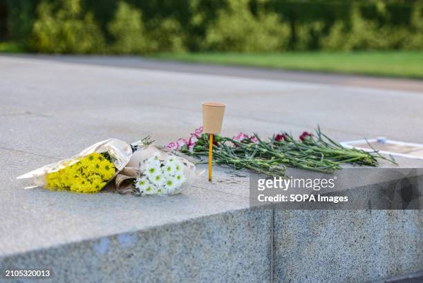 Makeshift memorial with flowers and mourning candles near the eternal flame at the Shrine of Remembrance in Melbourne to honor the victims of the...