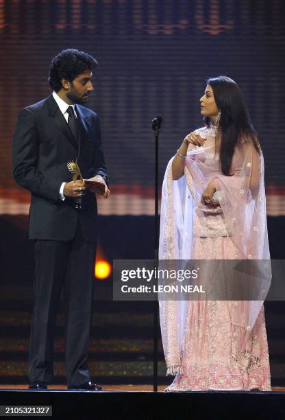 Indian actress Aishwarya Rai and her husband Abhishek Bachchan deliver a speech during the International Indian Film Academy Awards ceremony at the...