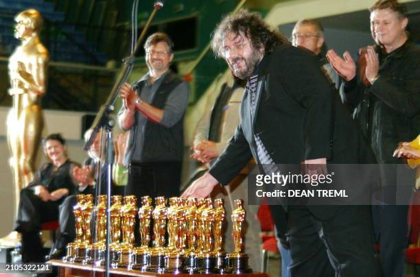 Lord of The Rings director Peter Jackson places his Best Director and Best Screenplay Oscars on a table with 20 others in front of the 3000 assembled...