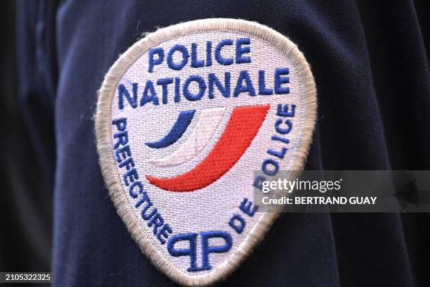This photograph taken in Paris on March 25, 2024 shows a coat-of-arms of France's National Police.