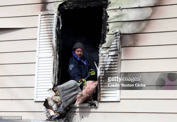 Newton, MA A member of the Massachusetts State Police helped to clean up the scene of a fatal fire on Walnut Street.
