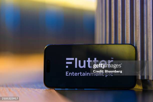 The logo of Flutter Entertainment Plc on a smartphone arranged in London, UK, on Monday, March 25, 2024. Flutter are to due to report their 2023 full...