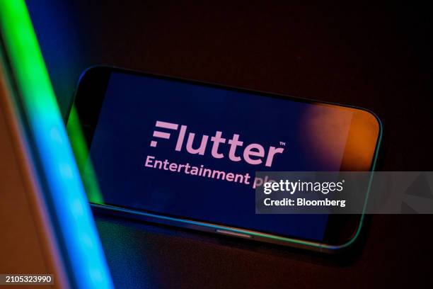 The logo of Flutter Entertainment Plc on a smartphone arranged in London, UK, on Monday, March 25, 2024. Flutter are to due to report their 2023 full...