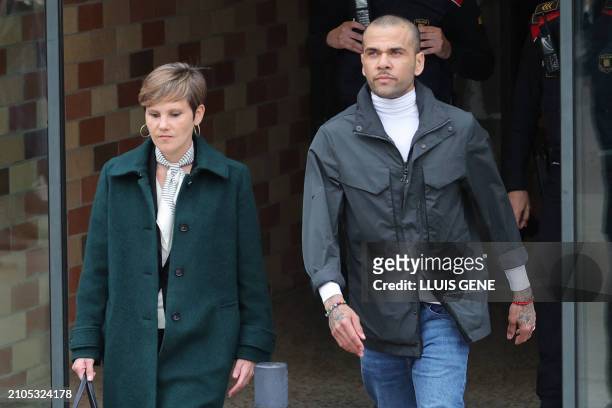 Convicted rapist and former Brazil international football player Dani Alves leaves on provisional release, flanked by his lawyer Ines Guardiola, at...