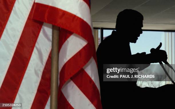 Presidential hopeful, Texas Governor George W. Bush is silhouetted while speaking at the Liberty Mutual Insurance center in Portsmouth, New Hampshire...