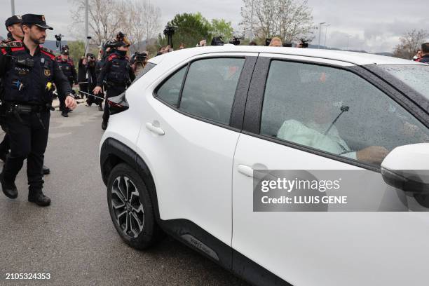 Convicted rapist and former Brazil international football player Dani Alves, in the back seat of the car, leaves on provisional release after posting...