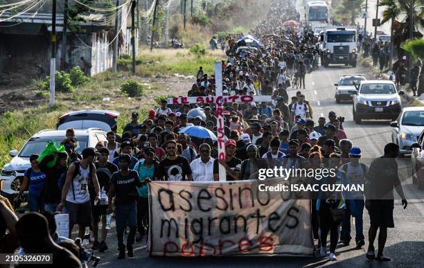 Group of migrants of different nationalities carry a cross leading a caravan that aims to reach the border between Mexico and the United States,...