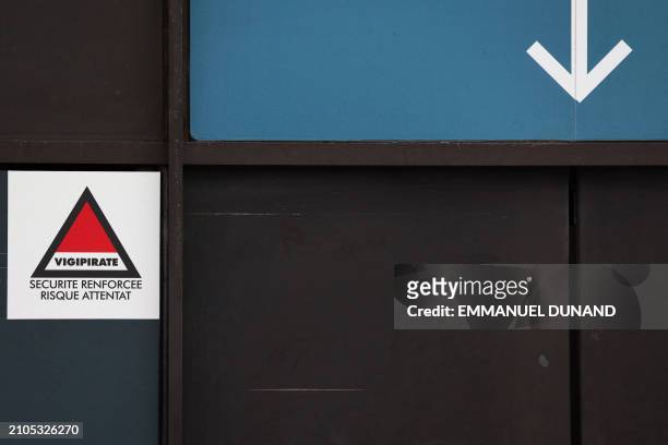 This photograph taken on March 25, 2024 shows the Vigipirate logo, of the level 2 over 3, "Securite renforcee risque attentat" , at the entrance of...