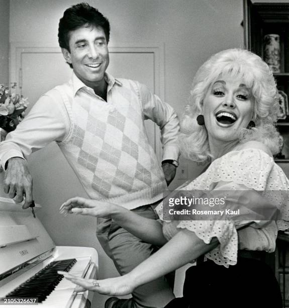 Talent manager Sandy Gallin and singer/songwriter Dolly Parton are photographed for the Los Angeles Times on September 22, 1983 in Los Angeles,...
