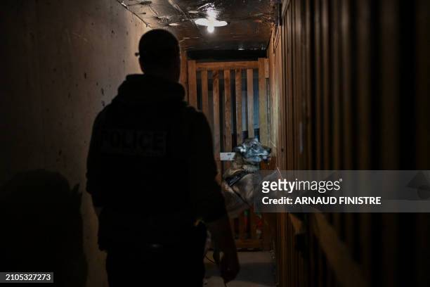Dog from the dog squad checks the basement of a building, in Chenove, central eastern France, on March 25 as part of the "XXL cleanup operation"...
