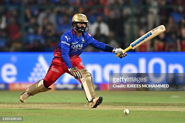 Royal Challengers Bengaluru's Dinesh Karthik watches the ball after playing a shot during the Indian Premier League Twenty20 cricket match between...
