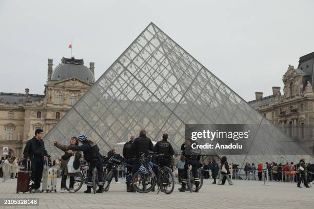 French police takes security measures near louvre pyramid as France raises alert to maximum after the terrorist attack in the Moscow concert hall...