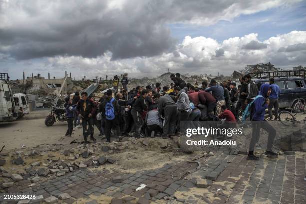 Palestinians rush to coast after humanitarian aids dropped from the air to Sudaniye region amid Israeli attacks in Gaza City, Gaza on March 25, 2024.