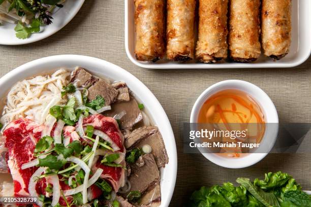 Ph c bit -rib eye, brisket, tendon & tripe rice noodle soup and phn ch giò -fried pork egg rolls served w/vegetables from Golden Deli on Friday, Nov....