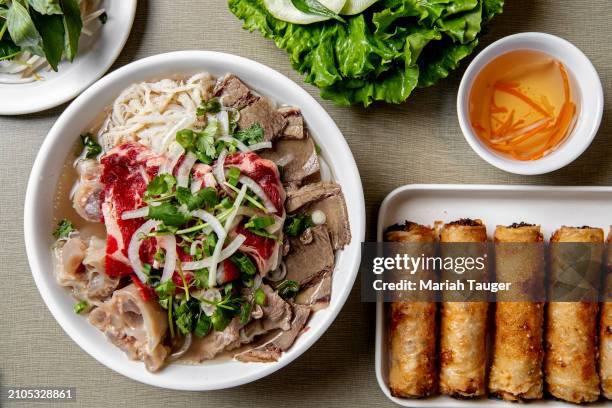 Ph c bit -rib eye, brisket, tendon & tripe rice noodle soup and phn ch giò -fried pork egg rolls served w/vegetables from Golden Deli on Friday, Nov....