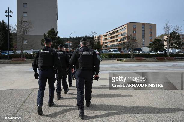 French gendarmes walk as they take part in the "XXL cleanup operation" launched simultaneously in several towns across the country to fight drug...