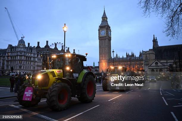 Farmers drive tractors in Westminster near the Houses of Parliament during a demonstration organised by Save British Farming on March 25, 2024 in...