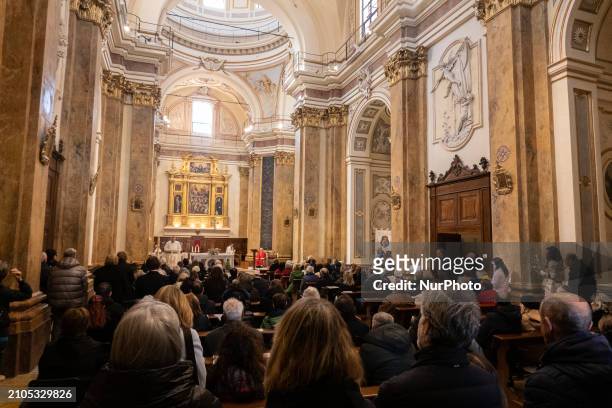 People attending a Holy Mass in Santa Maria del Suffragio church are seen in L'Aquila, Italy, on March 24th, 2024. Palm Sunday, observed on the...