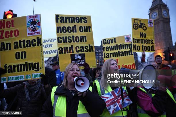 Protesters holding placards accompany farmers driving tractors through central London during a demonstration organised by Save British Farming...