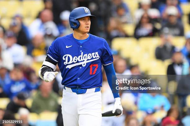 Los Angeles Dodgers designated hitter Shohei Ohtani looks on during the MLB Spring Training game between the Los Angeles Angels and the Los Angeles...