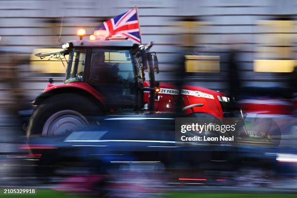 Farmers drive tractors in Westminster near the Houses of Parliament during a demonstration organised by Save British Farming on March 25, 2024 in...