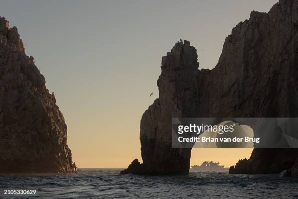 A boat is framed by the Arch of Cabo San Lucas...
