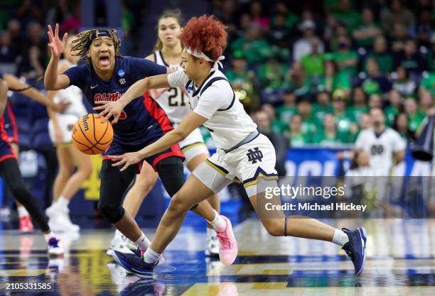 Hannah Hidalgo of the Notre Dame Fighting Irish passes a ball away from a reactive Kennedy Todd-Williams of the Ole Miss Rebels during the second...