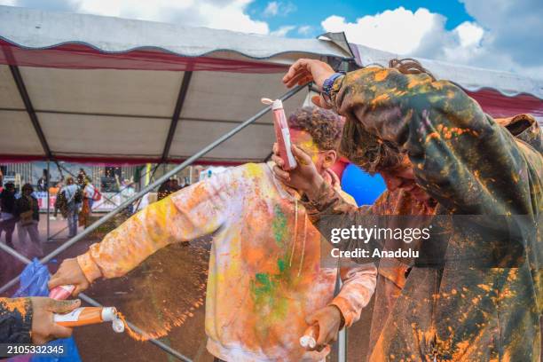 View of the celebration of Holi-Phagwa as they throw colored powder and spray water in the Transvaal district of The Hague, Netherlands on March 25,...