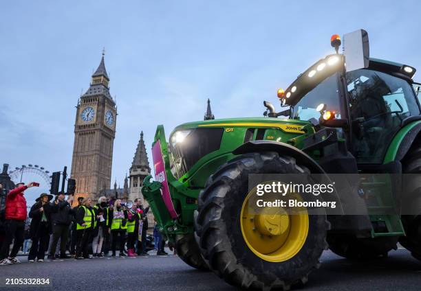 Farmer drives their tractor past the Houses of Parliament during a protest against issues including substandard food imports, in London, UK, on...