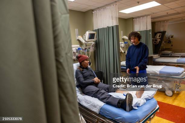 Mammoth Lakes, CA Mammoth Hospital emergency room nurse Kory Ferguson, right, asks Sharon Harrison, left, about her injured ankle Mammoth Mountain on...