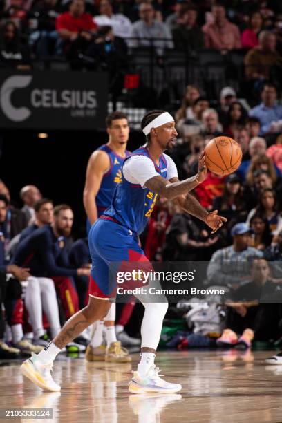 Kentavious Caldwell-Pope of the Denver Nuggets dribbles the ball during the game against the Portland Trail Blazers on March 23, 2024 at the Moda...