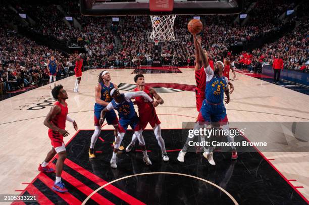 Kentavious Caldwell-Pope of the Denver Nuggets grabs a rebound during the game against the Portland Trail Blazers on March 23, 2024 at the Moda...