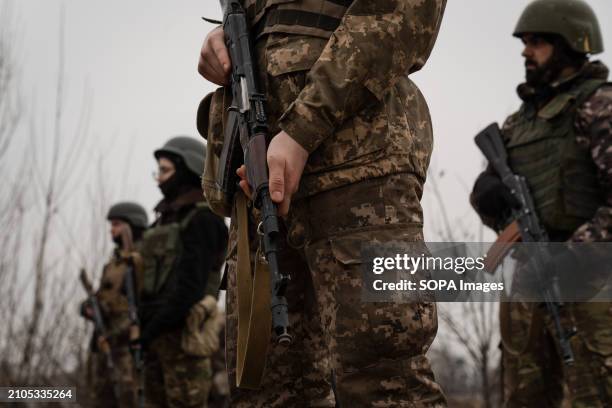 Trainees hold their rifle in a training organised by the third separate assault brigade in Kyiv region. Ukraine is facing a shortage of ammunition...