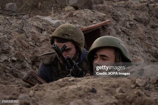 Trainees react during a training simulating an evacuation mission in the trench organised by the third separate assault brigade in Kyiv region....