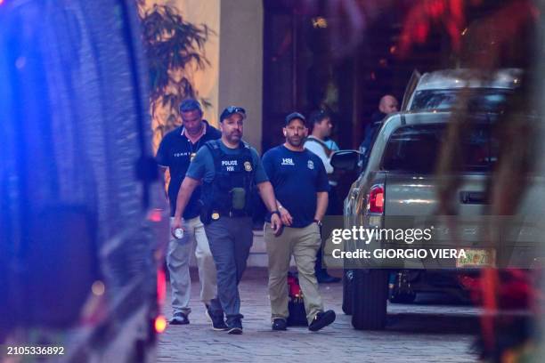 Homeland Security Investigation agents are seen at the entrance of US producer and musician Sean "Diddy" Combs's home at Star Island in Miami Beach...