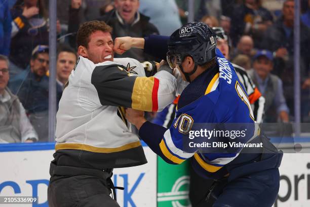 Brayden Schenn of the St. Louis Blues fights Brayden McNabb of the Vegas Golden Knights during the first period at Enterprise Center on March 25,...