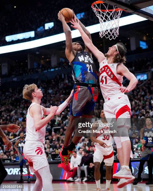 Noah Clowney of the Brooklyn Nets dunks against Kelly Olynyk of the Toronto Raptors during the first half at the Scotiabank Arena on March 25, 2024...