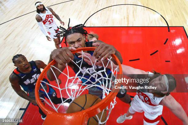 Noah Clowney of the Brooklyn Nets dunks the ball during the game against the Toronto Raptors on March 25, 2024 at the Scotiabank Arena in Toronto,...