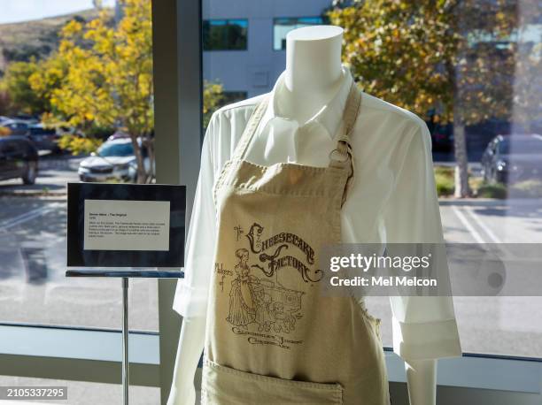 Khaki apron that was part of the original server attire when The Cheesecake first started back in 1978 is on display inside training center at their...