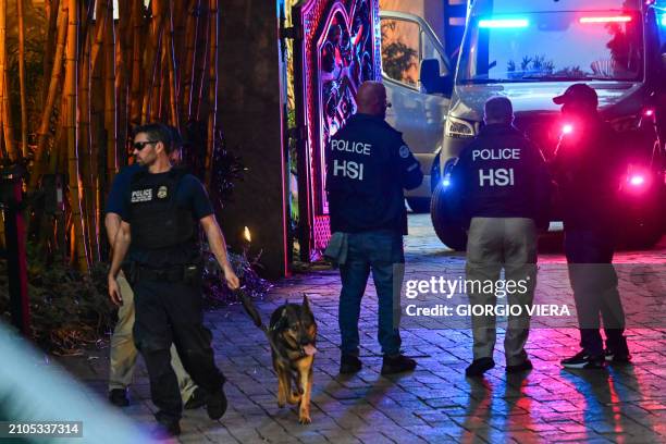 Homeland Security Investigation agents are seen at the entrance of US producer and musician Sean "Diddy" Combs's home at Star Island in Miami Beach...