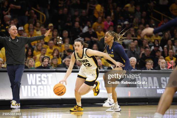 Caitlin Clark of the Iowa Hawkeyes drives in to the basket in the first quarter against the West Virginia Mountaneers during the second round of the...