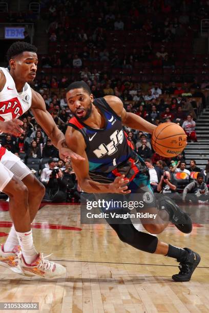 Mikal Bridges of the Brooklyn Nets handles the ball during the game against the Toronto Raptors on March 25, 2024 at the Scotiabank Arena in Toronto,...