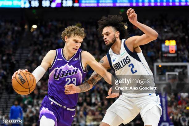 Lauri Markkanen of the Utah Jazz drives into Dereck Lively II of the Dallas Mavericks during the first half of a game at Delta Center on March 25,...