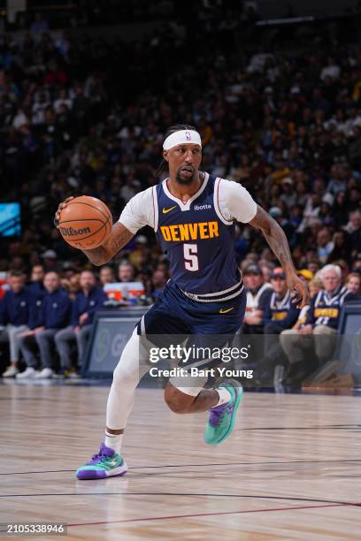 Kentavious Caldwell-Pope of the Denver Nuggets handles the ball during the game against the Memphis Grizzlies on March 25, 2024 at the Ball Arena in...