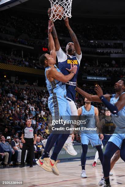 Kentavious Caldwell-Pope of the Denver Nuggets drives to the basket during the game against the Memphis Grizzlies on March 25, 2024 at the Ball Arena...